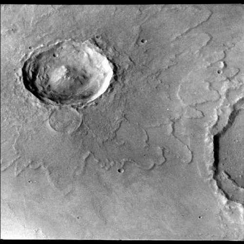 The splatter marks surrounding this impact crater suggest that the ground was water