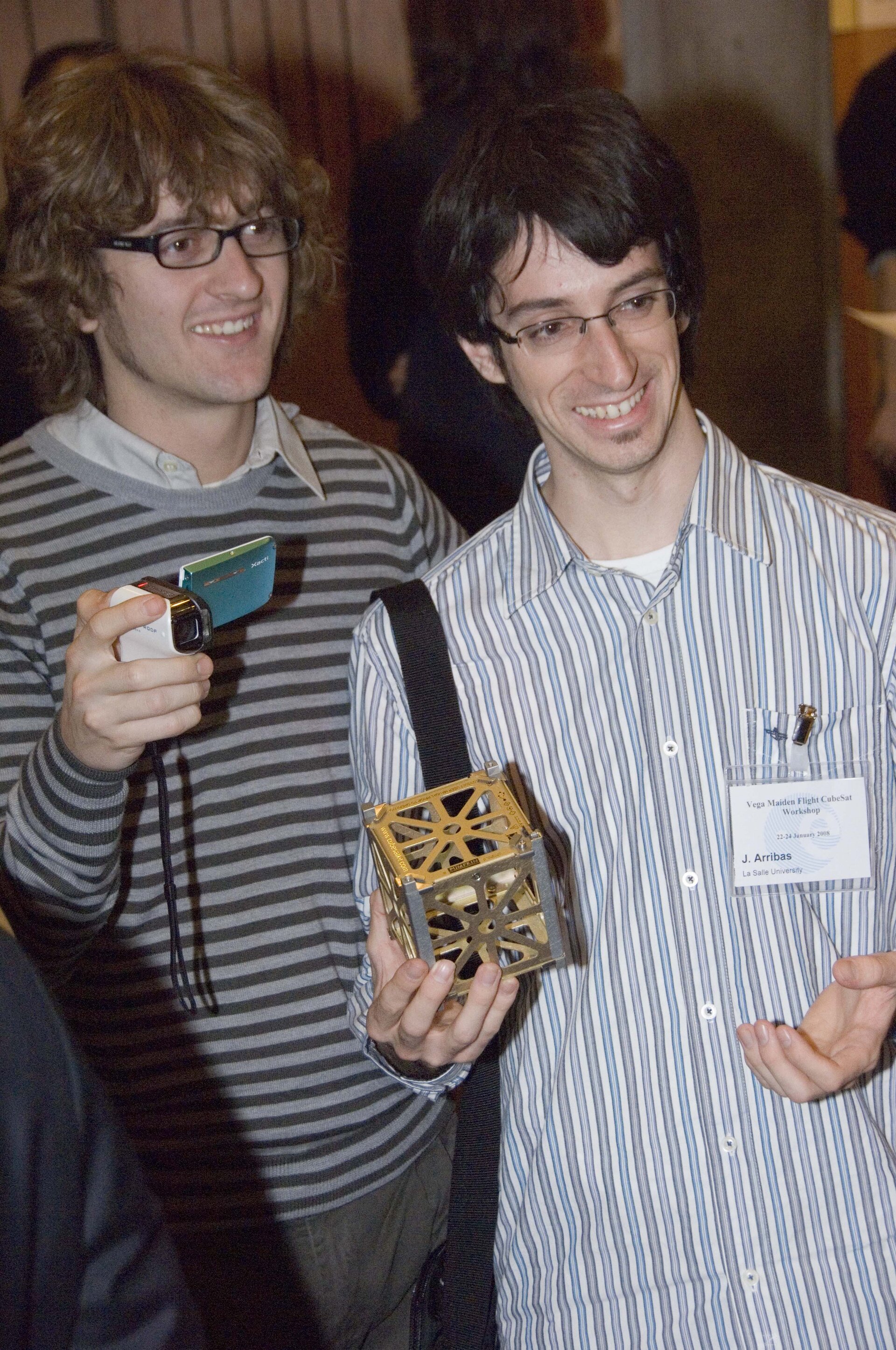 Students with a model CubeSat