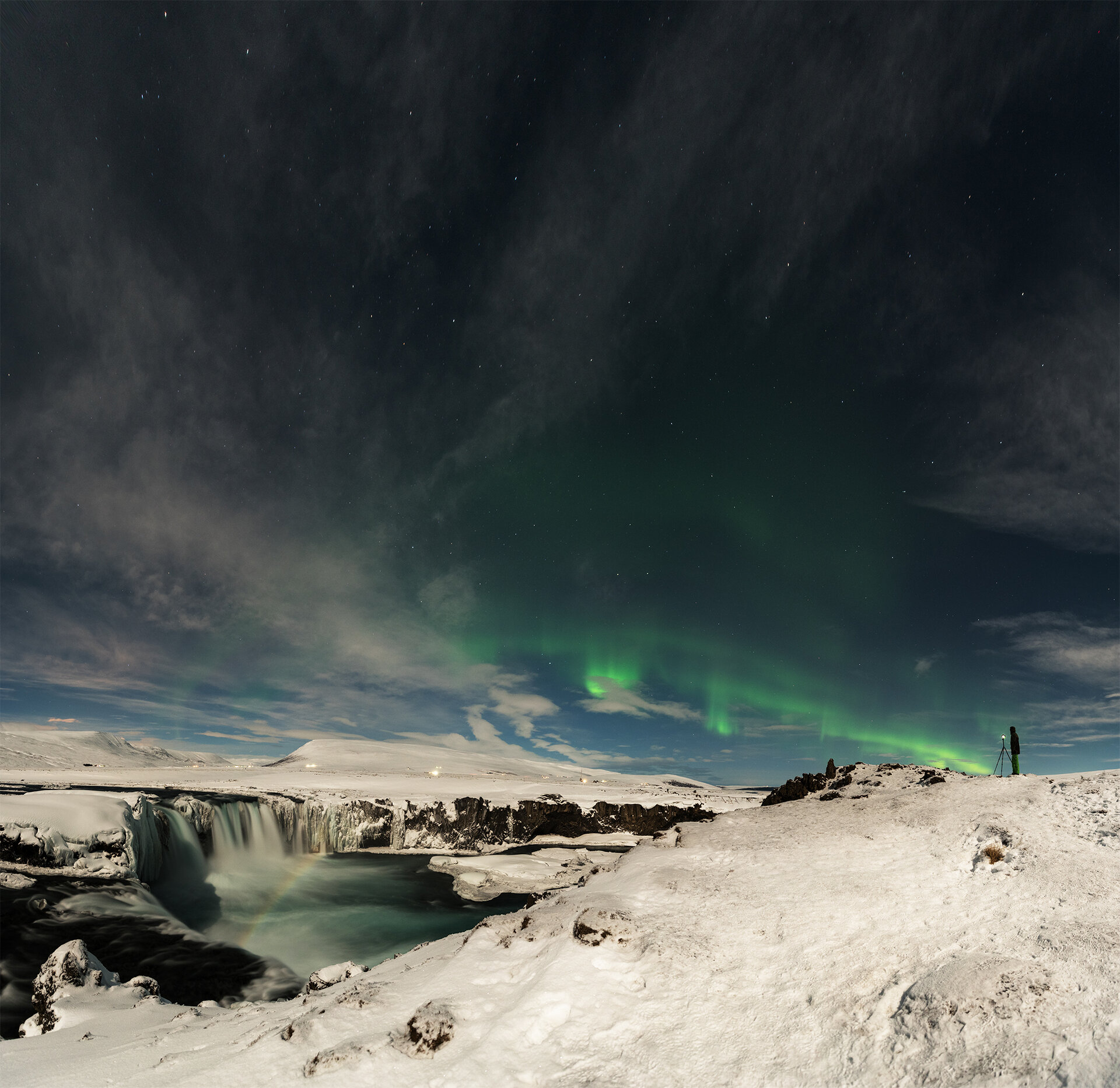 Rainbow over Iceland's Lake Mývatn under aurora