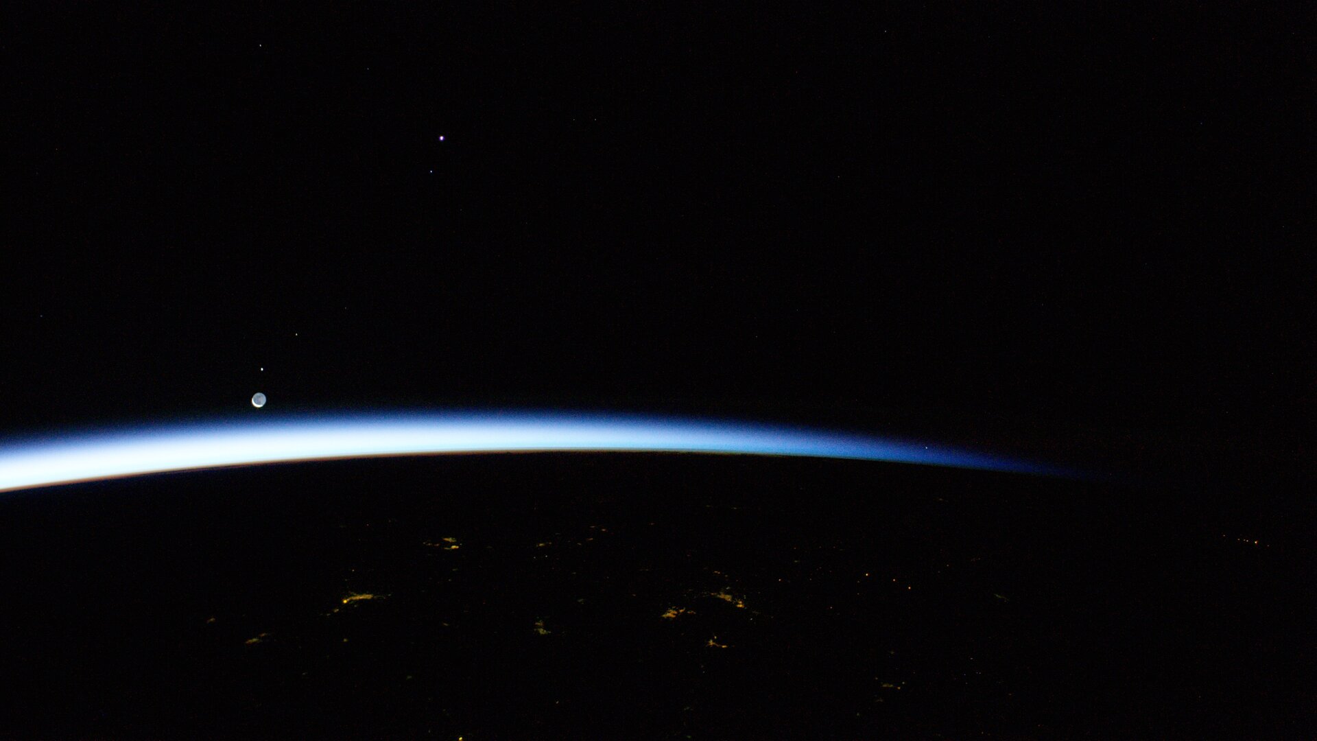 The Moon, Mars and Venus rising over Earth's horizon 