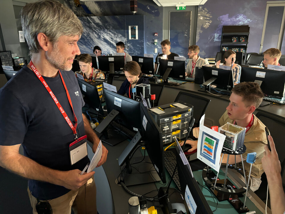 Students working on an educational satellite (ESAT) with Theia Space trainer. 