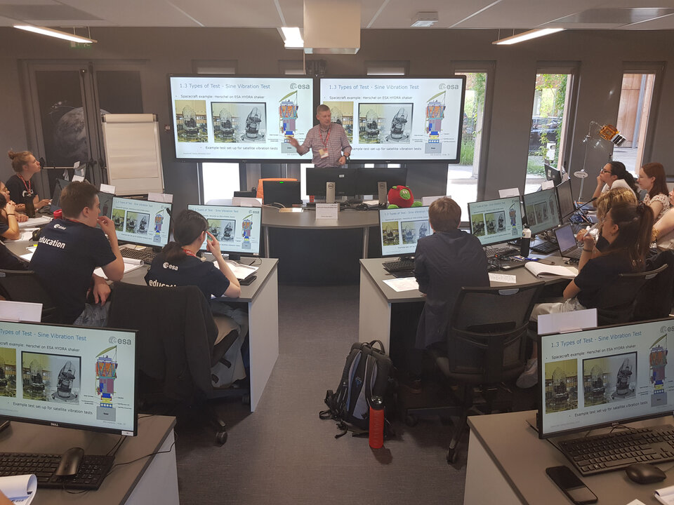 Students attending a lecture on vibration testing during the Spacecraft Testing Workshop
