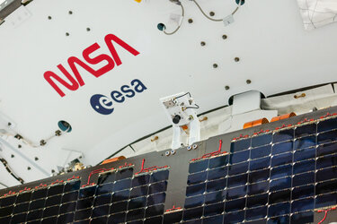 A solar array of the Orion spacecraft for Artemis II with the ESA and NASA logos