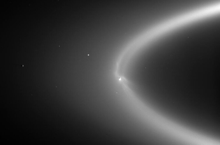 Enceladus orbiting within Saturn's E ring